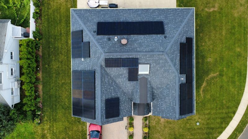 Overhead drone photo of a roof with solar panels and the backyard in Hicksville, NY