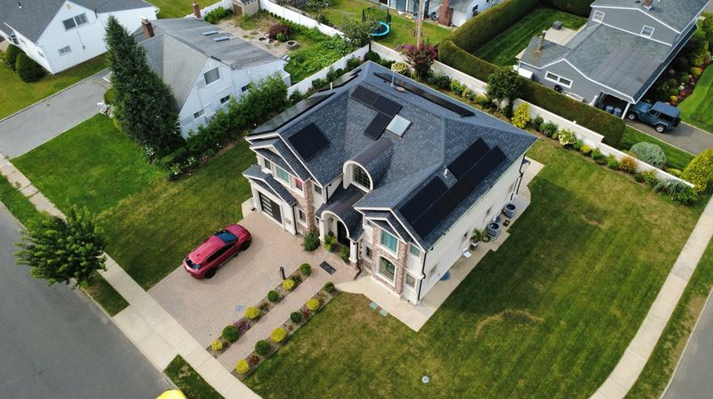 Drone photo of a home, driveway and neighboring yards in Hicksville, NY