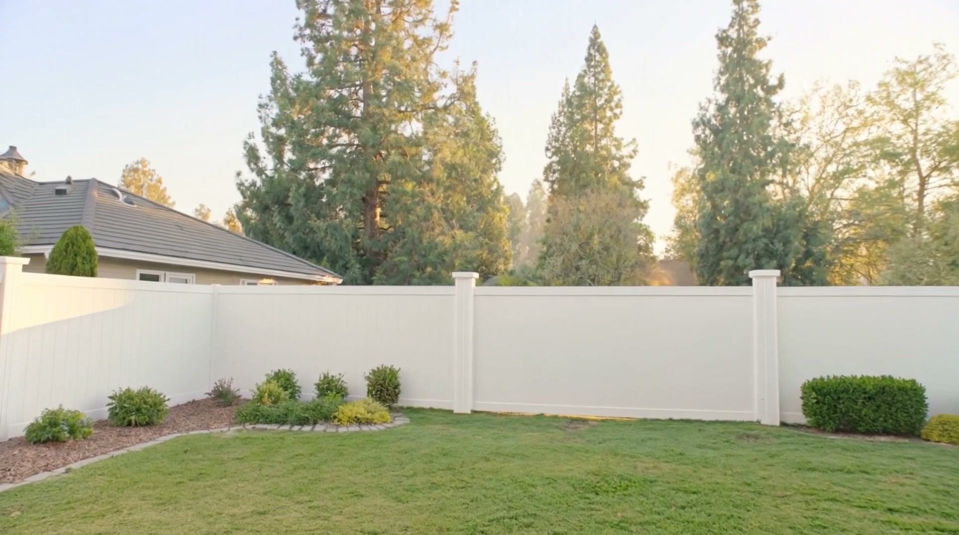 Fenced backyard with mature trees